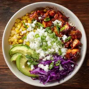 Overhead view of BBQ Chicken Cottage Cheese Bowl with avocado, corn, BBQ chicken, creamy cottage cheese, and purple cabbage