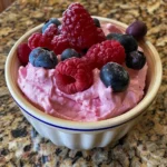 Creamy Berry Bliss Cottage Cheese Mousse topped with fresh raspberries, blueberries, and grapes