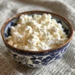 Creamy homemade cottage cheese served in a blue ceramic bowl
