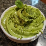 Creamy Matcha Green Tea Cottage Cheese Mousse topped with matcha powder and fresh mint